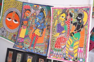 COLOURFUL: Buchidevi filling in her Madhubani paintings.