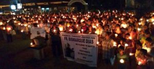 MOURNING: Supporters and fans of the late Fr Bismarque hold a candlelight vigil to mourn his untimely death and seek justice